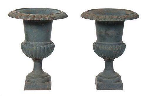 A Pair of Cast Iron Garden Urns Height 30 1/2 inches.