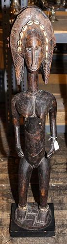 * A Bamana Carved Wood Figure of a Standing Female Height 41 1/2 x width 7 3/4 x depth 7 inches.