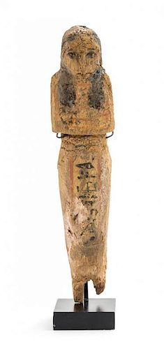 * An Egyptian Polychrome Painted Wood Shabti. Height 7 inches.
