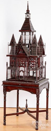 Elaborate carved mahogany birdcage on stand