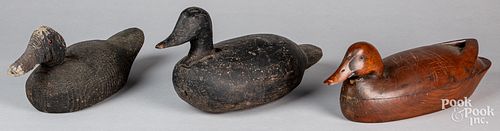 Three carved duck decoys.