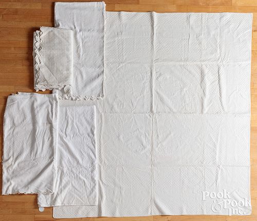 Five whitework quilts and bedspreads.