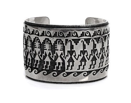 A Hopi Silver Cuff Bracelet, Phillip Honanie Length 5 7/8 x opening 1 1/8 x width 1 5/8 inches.