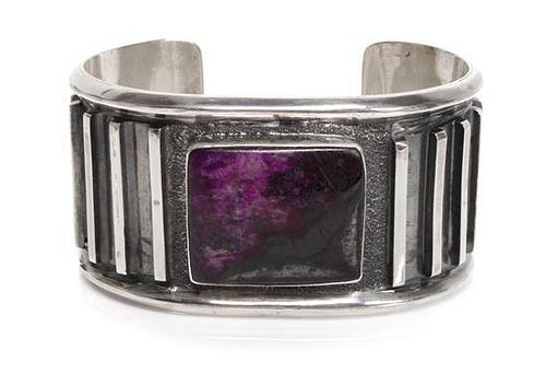 A Navajo Silver and Sugilite Cuff Bracelet Length 5 1/2 x opening 1 1/8 x width 1 3/8 inches.