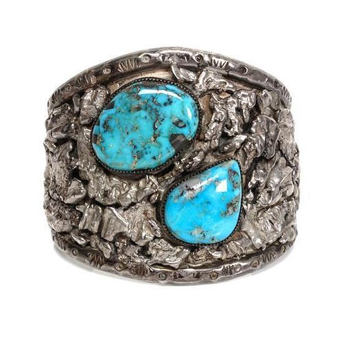 A Southwestern Silver and Turquoise Cuff Bracelet Length 5 3/4 x opening 1 1/4 x width 2 1/4 inches.