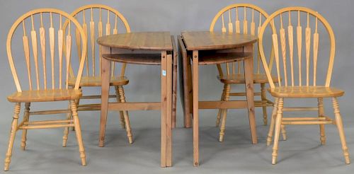 Six piece lot including two part table and four oak chairs. dia. 39 1/4in.