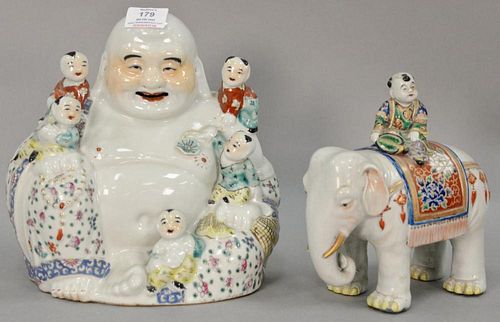 Two Oriental porcelain figural pieces including Budha with boys and an elephant having enameled flower rug and a boy on it. ht. 8 1/...