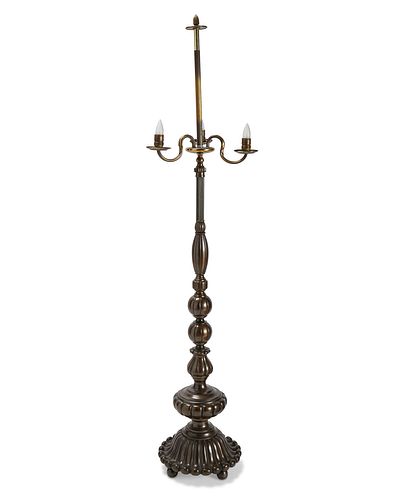 A tall patinated brass floor lamp