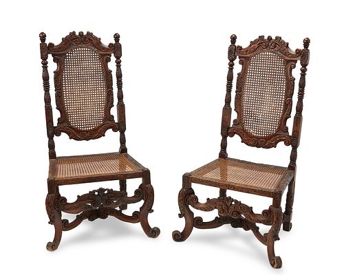 A pair of Baroque-style carved wood and cane chairs