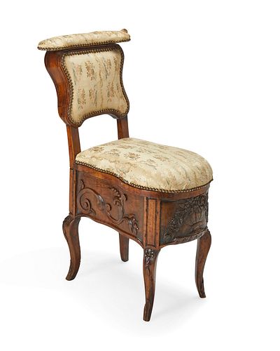 A French carved wood commode chair