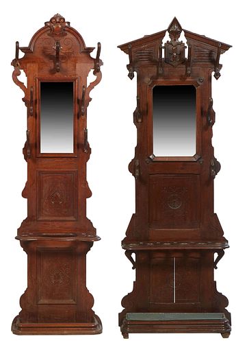 Two French Provincial Carved Oak Hallstands, late 19th c., one with a peaked top over four wood double hooks above a rectangular mirror flanked by fou