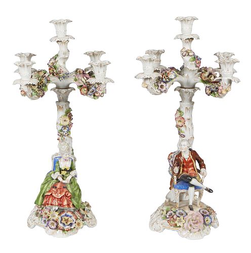 Pair of German Porcelain Dresden Style Figural Five Light Candelabra, 20th c., by Plaue Schierholz, with applied floral decoration, each with a seated