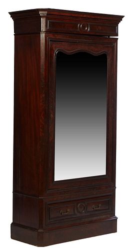 American Single Door Carved Mahogany Armoire, 19th c., the stepped canted corner crown over a mirror door, on a base with a long drawer, over a bottom
