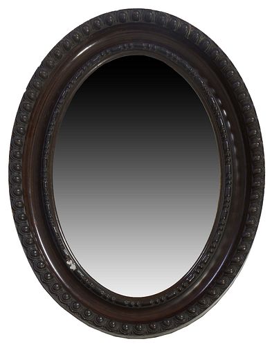 Large American Oval Gesso Mirror, late 19th c., the wide cove molded frame with a relief gesso "button" border around a dot and dash relief liner and 