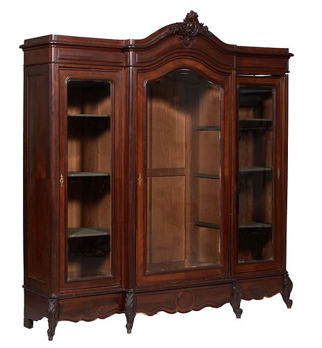 French Louis XV Style Carved Walnut Triple Door Armoire, early 20th c., the arched C-scroll crest over a stepped crown above a wide beveled glass cent