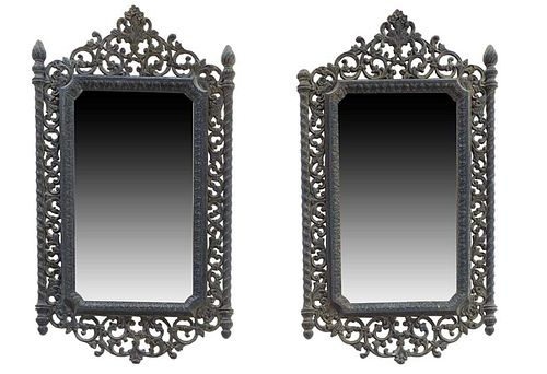 Pair of Renaissance Style Ebonized Mirrors, early 20th c., with a pierced floral crest flanked by flame topped pierced sides to a pierced bottom surmo
