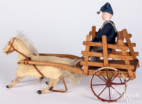 Bisque head figure in cart, with wind-up horse