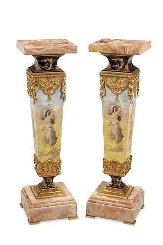 A pair of French onyx and porcelain pedestals