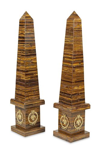 A pair of monumental tiger's eye obelisks