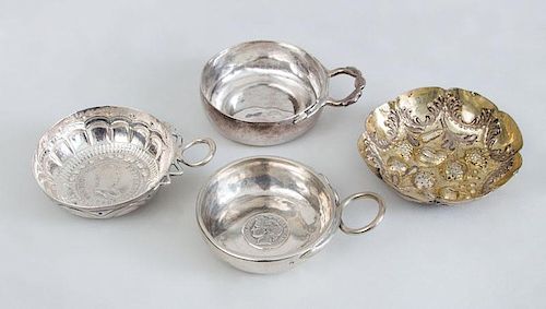 SPANISH COIN-MOUNTED SILVER WINE TASTER, A FRENCH COIN-MOUNTED SILVER TASTER, UNEMBELLISHED TASTER AND A GOLD-WASH TASTER