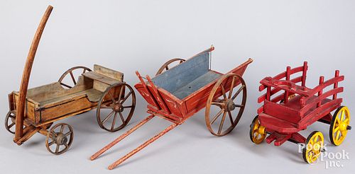 Three wooden toy wagons and cart, ca. 1900