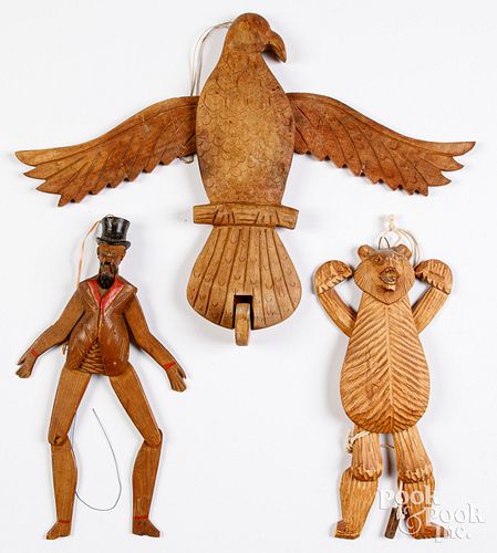 Three carved jumping jack toys