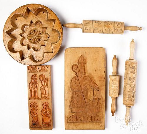 Group of carved food molds and pastry rolling pins