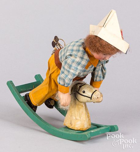 Wind-up bisque head doll on rocking horse