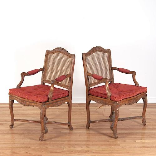 Pair Regence carved walnut open armchairs