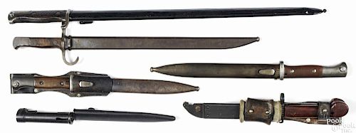 Six bayonets and scabbards, to include two German K-98, a FAL bayonet, a German Gewehr 98