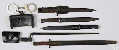 Miscellaneous militaria, to include eight bayonets and scabbards, a NGP 45-70 cartridge box