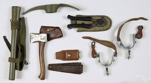 Miscellaneous military items, to include a US marked pick axe, wire cutters, a signal corp sheath