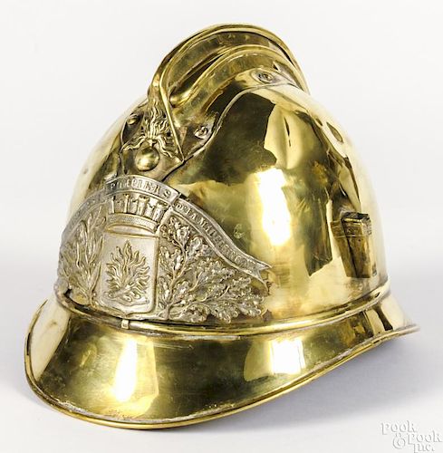 French brass fire helmet, ca. 1900, with a placard inscribed Sapeurs Pompiers Dela Madeleine