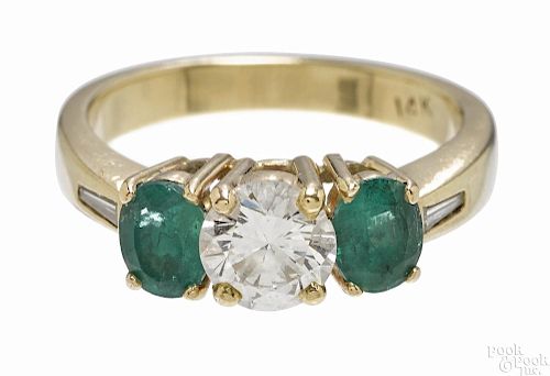 14K yellow gold, diamond, and emerald ring with a round cut central diamond, .75ct