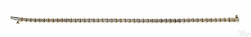 14K yellow gold and diamond tennis bracelet with forty-nine round, brilliant cut diamonds