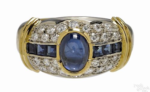 18K yellow gold, diamond, and sapphire ring with a central oval sapphire cabochon
