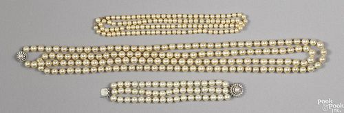 Two faux pearl necklaces, one with a 14K white gold clasp, 70'' l. and 37'' l.