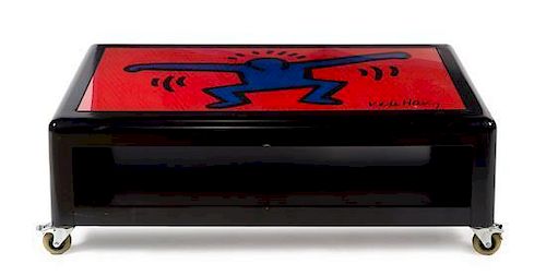 * A Keith Haring Low Table, by Bretz, CIRCA 1998, black lacquered rectangular top decorated with an iconic Keith Haring figur
