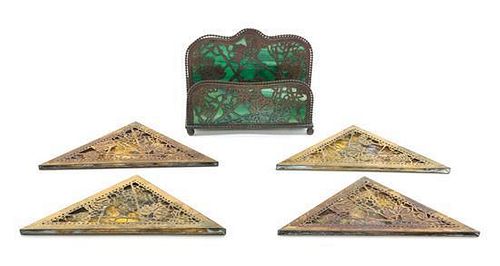 Tiffany Studios, a set of four blotter corners, together with a letter rack