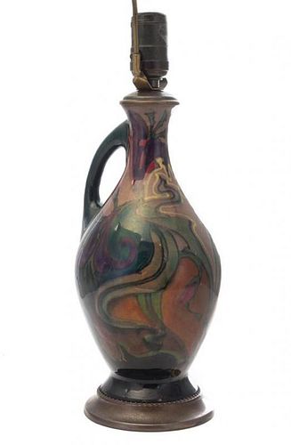 * A Gouda Pottery Ewer, Leendert Muller, EARLY 20TH CENTURY, of handled form with stylized foliate decoration, mounted as a l