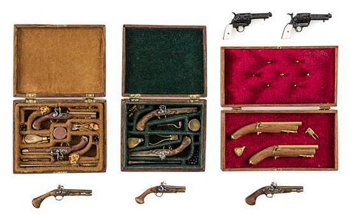 A Group of Cased Dueling Pistol Sets Width of widest case 2 1/4 inches.