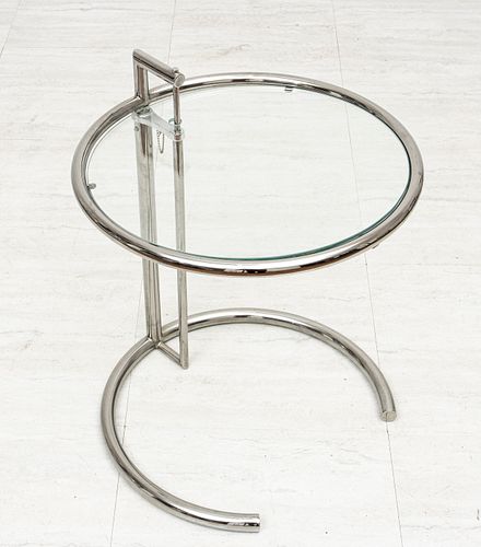 IN THE STYLE OF EILEEN GRAY (IRISH, 1878–1976) ADJUSTABLE CHROMED STEEL & GLASS OCCASIONAL TABLE