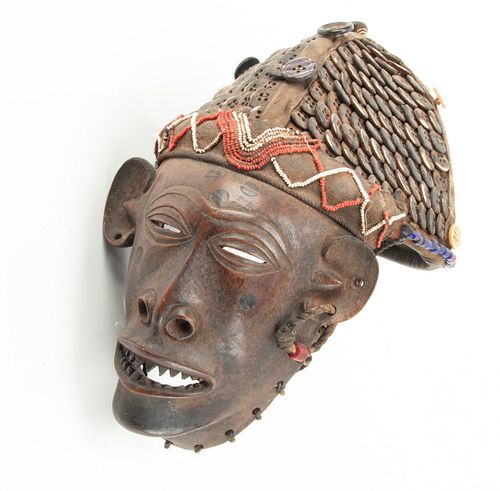 BATSHIOKO, ZAIRE AFRICAN CARVED WOOD MASK WITH TEXTILE, FIBER, BEADWORK AND BUTTONS, H 12", W 8" 
