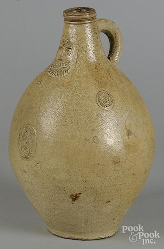 Stoneware Bellarmine jug, 17th/18th c., with relief decoration of a bearded mask, 15'' h.