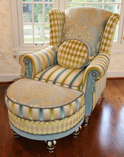 MACKENZIE-CHILDS (AMERICAN) UPHOLSTERED WINGBACK ARMCHAIR AND OTTOMAN, H 42.5" W 35" D 39" 
