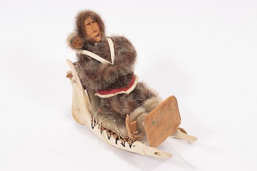 INUIT  FUR CLAD  DOLL AND JAWBONE SLED C. 1960 H 9.5" L 9.5" 