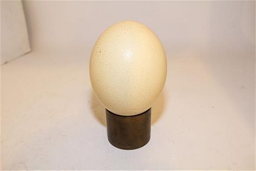 An Ostrich Egg and Associated Brass Stand. Length of ostrich egg 5 3/4 inches.