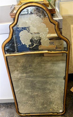 A Gilt and Ebonized Mirror. Length 38 inches.