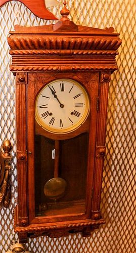 * A Late Victorian Carved Oak Wall Clock. Height 38 inches.