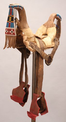 NATIVE AMERICAN WOOD, RAWHIDE, LEATHER AND BEADED WOMAN'S SADDLE, EARLY 20TH C., H 15" W 12" L 30" 